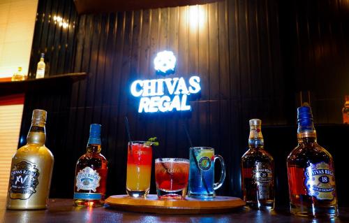 a bar with several bottles and glasses of alcohol at Southern Sun Abu Dhabi in Abu Dhabi