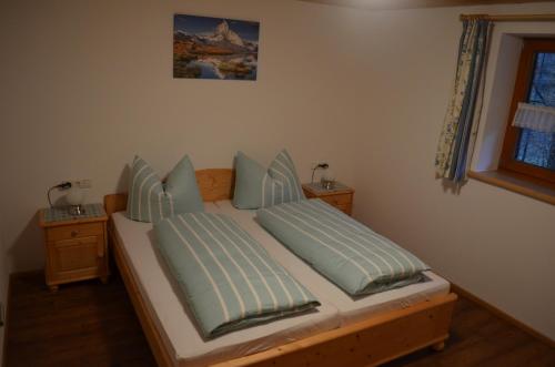 a bedroom with a bed with two pillows at Haseltopf in Oberstdorf
