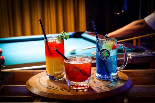 two drinks on a tray next to a pool table at Southern Sun Abu Dhabi in Abu Dhabi