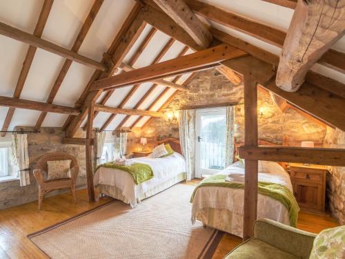 a bedroom with two beds in a attic at The Granary in Hawnby