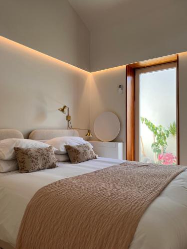 a bedroom with two beds and a large window at CASA DOS OLIVAIS in Porto
