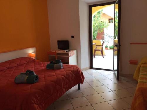 a bedroom with a bed with two bags on it at Affittacamere Casa del Sole in Cala Gonone