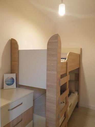 a room with a desk and a wooden book shelf at GONIO Beachfront Cosy Apartment in Gonio