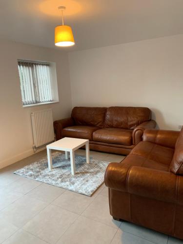 a living room with a couch and a table at Campion Place in Sheffield