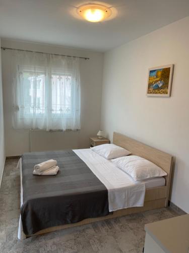 a bedroom with a bed with two towels on it at Villa Magnolia in Privlaka