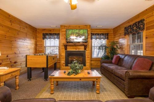 a living room with a couch and a fireplace at Briarstone Lodge Condo 13F in Pigeon Forge