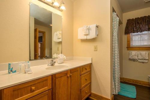 a bathroom with a sink and a mirror at Briarstone Lodge Condo 13F in Pigeon Forge
