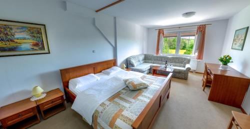 um quarto com uma cama e uma sala de estar em Gostišče - Guest house STARI HRAST em Ljutomer