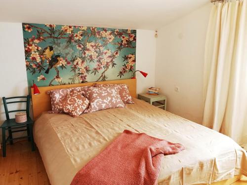 a bedroom with a bed with a painting on the wall at Vila Verbana Apartments in Vrbnik