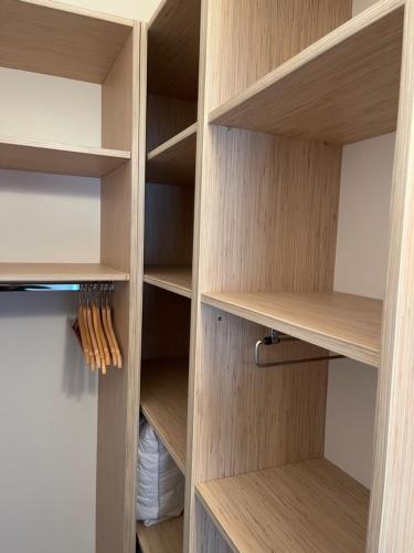 a cupboard with wooden shelves in a room at Villa Magnolia in Privlaka