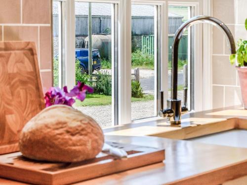 a loaf of bread on a cutting board on a kitchen counter at Limber Wold House in Great Limber