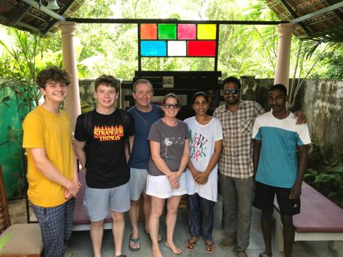 a group of people standing in front of a stained glass window at Mandaram villas in Mararikulam