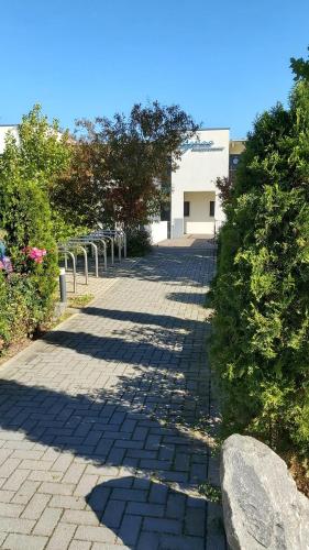 a brick walkway with a building in the background at Laguna Seeappartements in Neukieritzsch