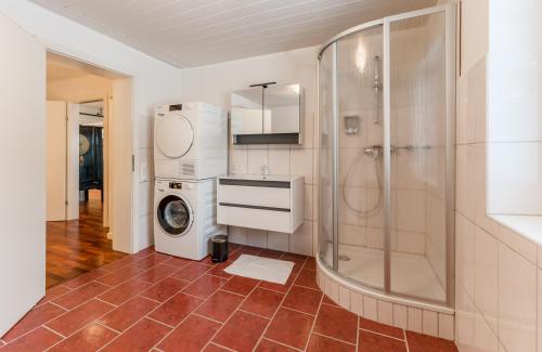 a bathroom with a shower and a washing machine at QUARTIER 179 in Schladming