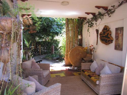 a living room with wicker couches at Hotel Boutique Terra Diaguita & Spa in La Serena