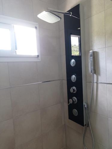 a bathroom with a shower with a window at AROMA DEL POTRERO PISCINA CLIMATIZADA CUBIERTA disponible desde Septiembre in Potrero de los Funes
