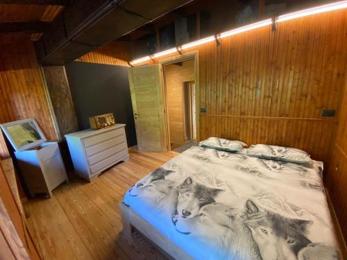 a bedroom with a bed with wolves on it at La Baita D’Nonou in SantʼAnna di Valdieri