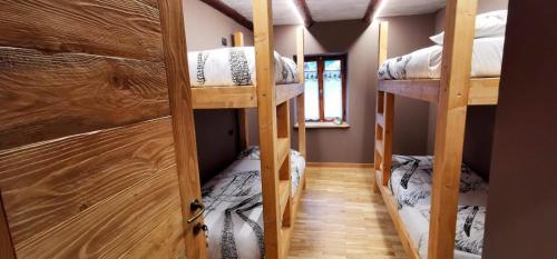 a room with two bunk beds in a house at La Baita D’Nonou in SantʼAnna di Valdieri