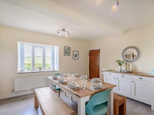 a dining room with a table and a kitchen at Middle Bank Top Farm - Uk39183 in Rossendale