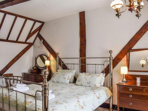 a bedroom with a bed and a dresser with a mirror at Heritage Lodge in Rhyl