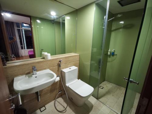 a bathroom with a toilet and a sink and a shower at Vortex Suites KLCC by Fortune in Kuala Lumpur