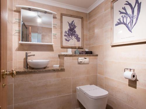 a bathroom with a toilet and a sink at Solent View Apartment in West Cowes