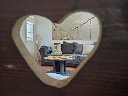 a living room with a couch and a table at Chez le Petit Peintre in Laboissière-en-Thelle