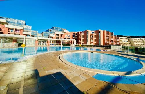 a swimming pool in the middle of a building at ''559 Cap corniche'' T2 en résidence front de mer! in Sète
