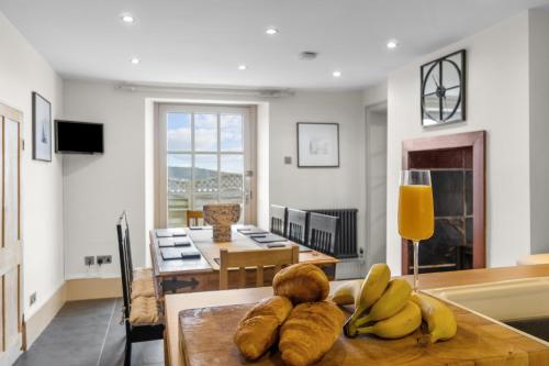 a living room with a table with bananas on it at NEW 2023 Modern Luxury Holiday Home on the Beach in Devon - Free Parking, Pets Welcome, Sleeps 10 in Plymouth