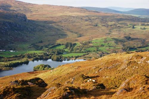 a view from the top of a hill with a lake at Gougane Barra Hotel in Ballingeary