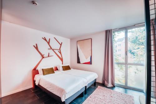 Cama o camas de una habitación en COWOOL Cergy