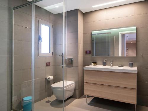 a bathroom with a toilet and a glass shower at Central Athens Loft in Athens