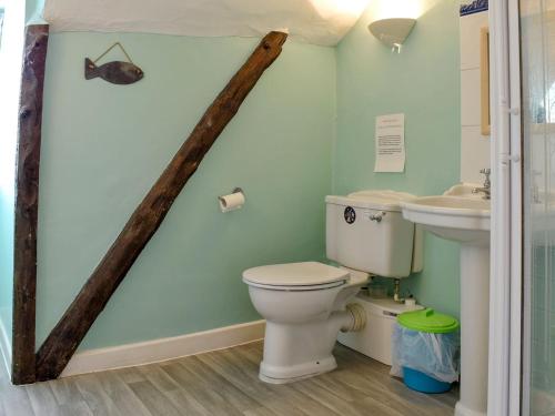 a bathroom with a toilet and a sink at Old Town Cottage in Sidmouth