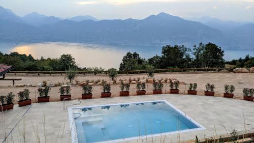 a swimming pool with a view of a lake at Agricampeggio La Part ONLY CAMPER in San Zeno di Montagna