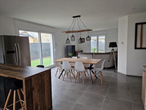 a kitchen and dining room with a table and chairs at Maison avec jacuzzi et sauna in Épinal