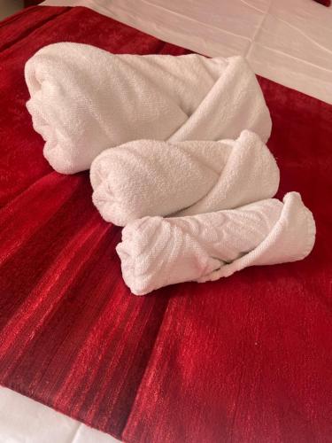 a pile of white towels sitting on a bed at Ribarska Sreshta Family Hotel in Tsarevo