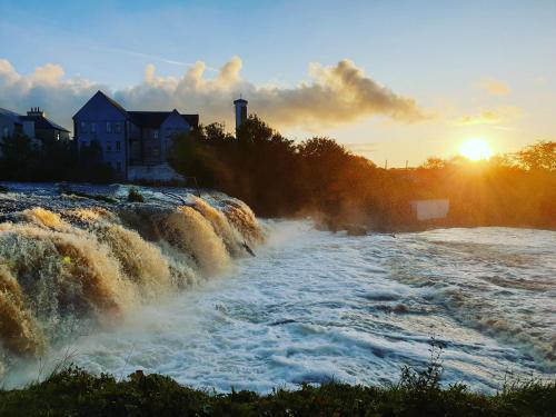 a river with rapids on it at sunset at Atlantic Coast Lodge in Spanish Point