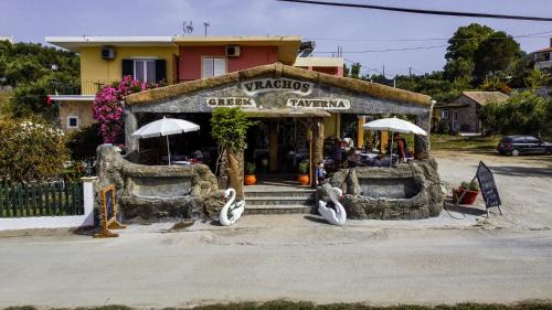 a restaurant with umbrellas in front of a building at Anna Studios in Marathias