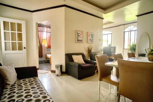 a living room with a couch and a table at Pallet Homes - Landheights in Iloilo City