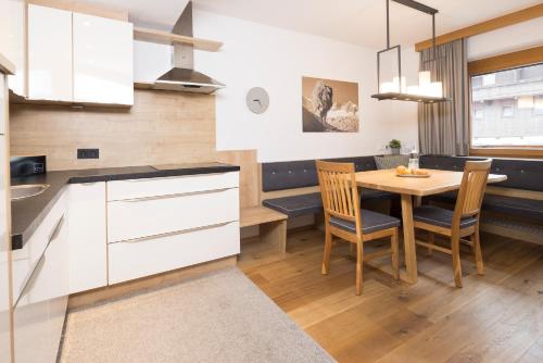 a kitchen and dining room with a table and chairs at Haus Sylvia in Reith im Alpbachtal
