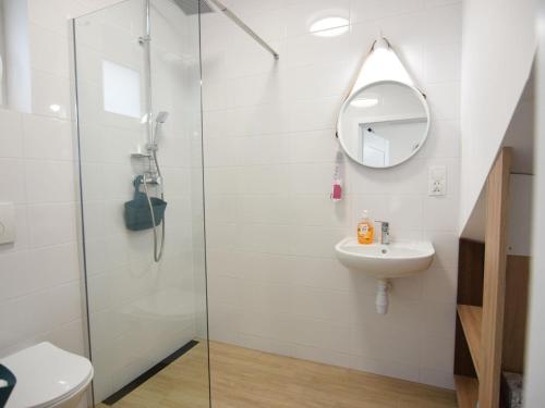 a bathroom with a shower and a sink at Modern holiday homes directly on the lake in Kiedrowice in Kiedrowice