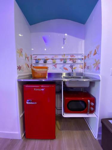 a small kitchen with a sink and a red refrigerator at Ventidue Venti in Bari
