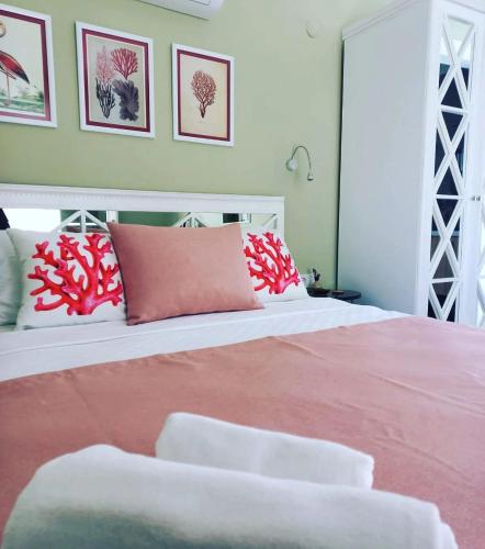 a bedroom with a large bed with red and white pillows at Zarbalı Cunda in Ayvalık