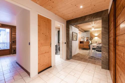 a hallway with a wooden door and a dining room at Appartement Europa in Briançon