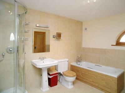 a bathroom with a sink and a toilet and a shower at The Stables in Filby