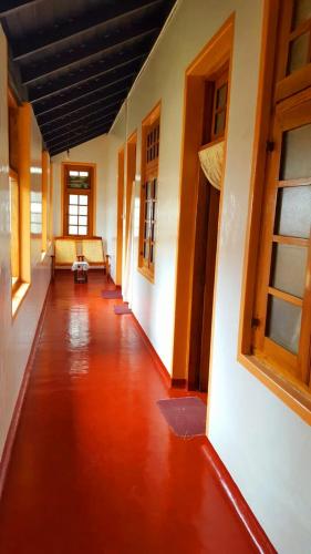 an empty hallway of a building with a couch in it at Bel View Guest House in Haputale