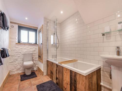 a bathroom with a tub and a toilet and a sink at Russet-uk41836 in Clevedon