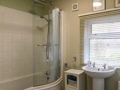 a bathroom with a sink and a shower and a sink at Riverside House in Beccles