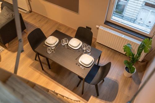 an overhead view of a dining room table and chairs at Golden Dove Luxury Aparts in Brussels