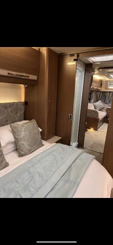 a bedroom with a large bed in a room at Self Contained Holiday Home Caravan in Corsham